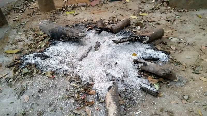 The charred remains of the campfire